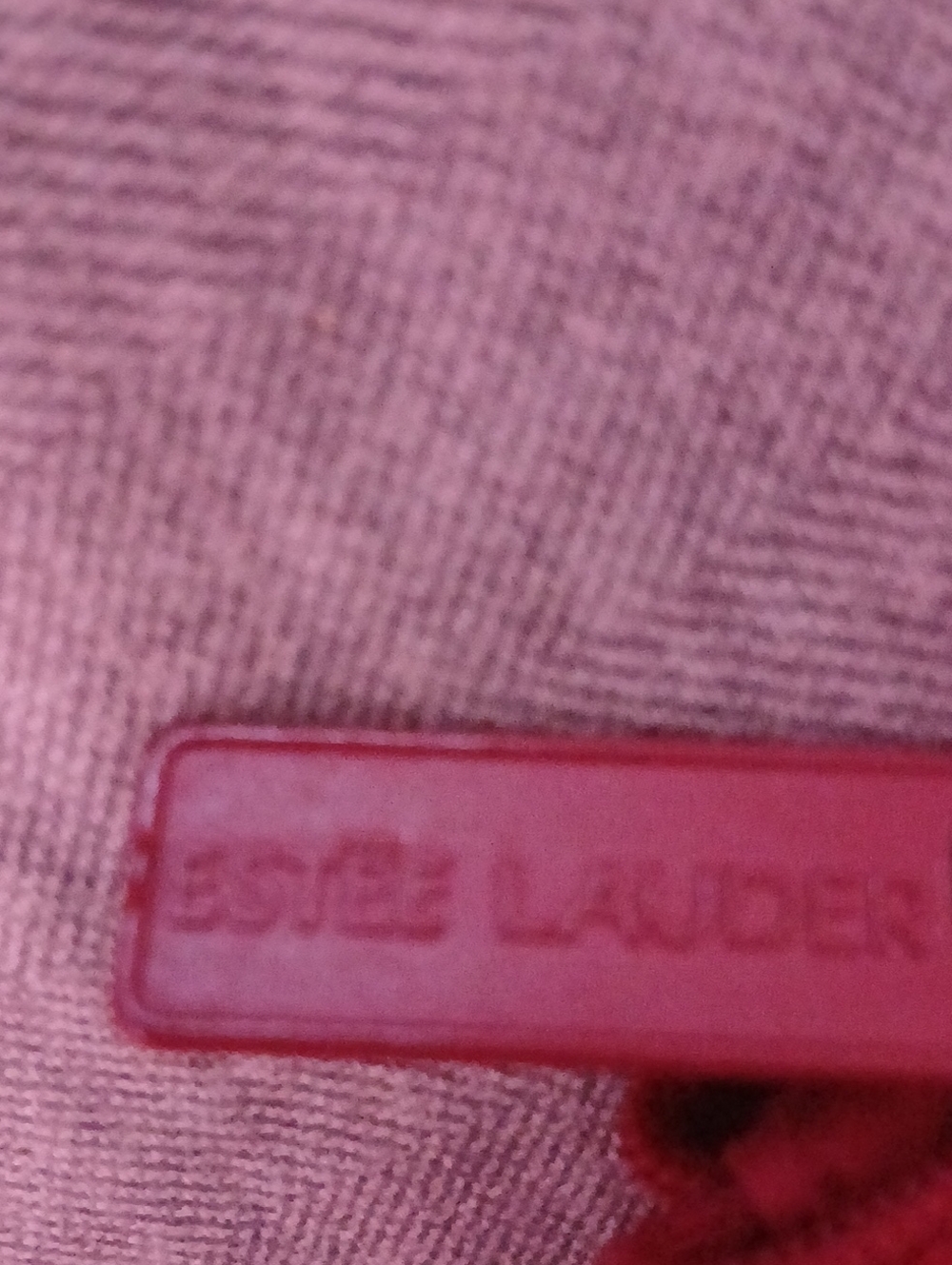 Estee Lauder Red embossed cosmetic zipper pull